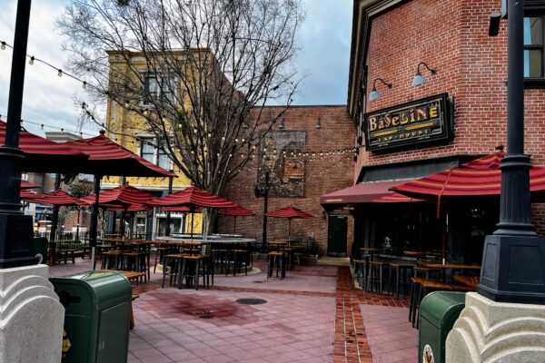 Baseline Tap House at Hollywood Studios, with outdoor seating and red umbrellas.