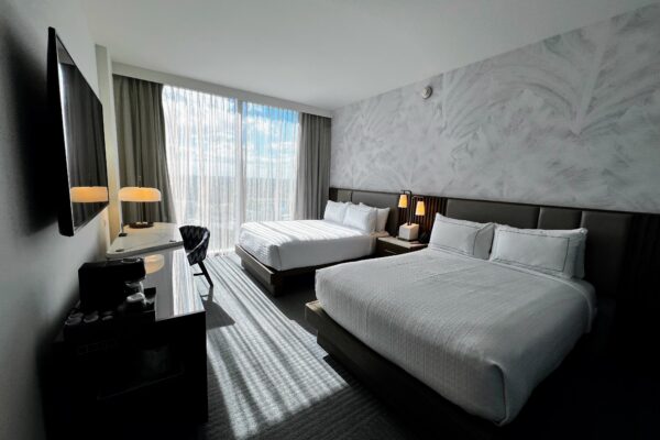 Modern hotel room with two queen beds and city view