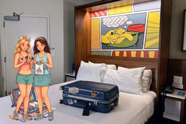 Two women in Disney-themed attire stand by a bed with a suitcase, ready for a trip.