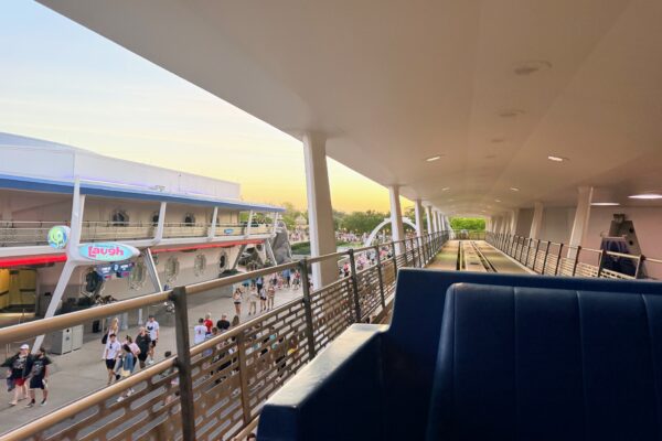 Tomorrowland PeopleMover at Magic Kingdom, with guests walking below.