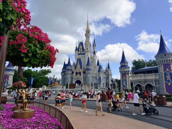 Cinderella Castle at Magic Kingdom, with adults enjoying the park