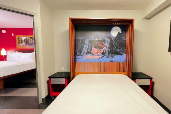 Disney Cars-themed room with Mater mural and bunk beds for adults.