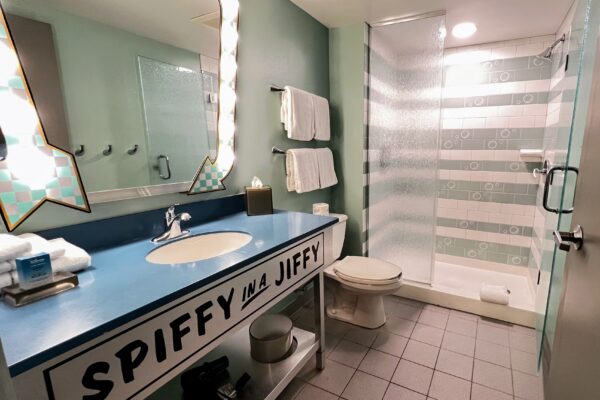 Disney room bathroom with "Spiffy in a Jiffy" text on vanity