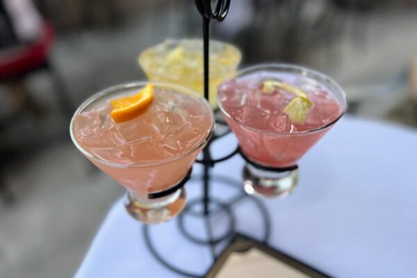 Pink and yellow cocktails on a table, perfect for a Disney bachelorette party.