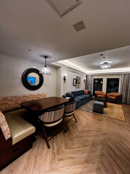 DVC resort living room with dining nook, blue sofa, and cozy seating