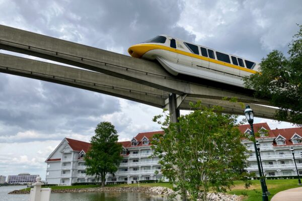 Disney monorail passes over a resort hotel, perfect for DVC group trips.