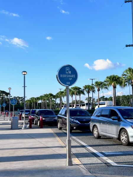 Lyft rideshare pickup sign at Disney World with cars waiting