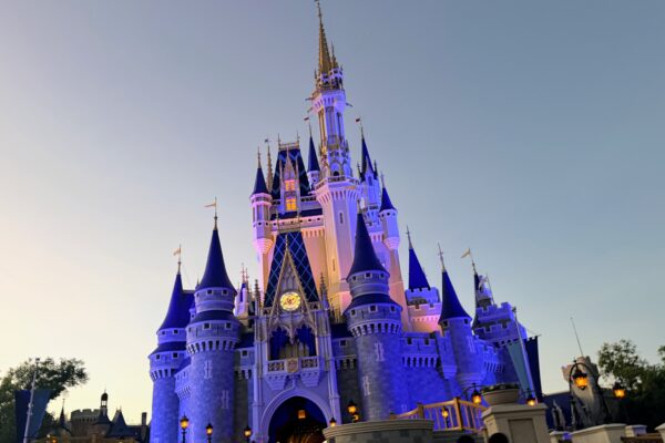 Cinderella Castle at Magic Kingdom, lit up at dusk, for Disney World trips.